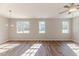Bright living room with wood floors, pendant lighting, and large windows at 806 Roberts Rd, Sanford, NC 27332