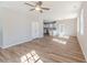 Open-concept living space featuring wood floors that seamlessly flow into the modern kitchen at 806 Roberts Rd, Sanford, NC 27332