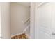 View of a staircase with carpeted steps, a white handrail and a wood-look floor below at 806 Roberts Rd, Sanford, NC 27332