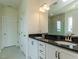 Bathroom features dual sinks, granite countertops, and tile flooring at 8305 Cannon Grove Dr, Willow Springs, NC 27592