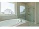 Modern bathroom with soaking tub and glass-enclosed shower at 8305 Cannon Grove Dr, Willow Springs, NC 27592