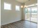 Dining room with modern chandelier and sliding glass doors leading to outdoor patio at 8305 Cannon Grove Dr, Willow Springs, NC 27592