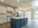 Modern kitchen with white cabinets, stainless steel appliances, and a center island at 8305 Cannon Grove Dr, Willow Springs, NC 27592