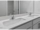 Bathroom featuring white cabinets and double sinks and large mirror at 98 Ethel Ln, Angier, NC 27501