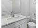 Bright bathroom featuring a sleek vanity with quartz countertop and a modern faucet at 98 Ethel Ln, Angier, NC 27501