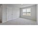 Bedroom featuring neutral walls, carpet, a window with natural light and a door at 98 Ethel Ln, Angier, NC 27501