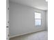 Bedroom with neutral walls, carpet, a window with natural light and a door at 98 Ethel Ln, Angier, NC 27501