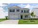 Charming two-story home features a clean gray facade, attached garage, and manicured lawn at 98 Ethel Ln, Angier, NC 27501