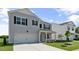 Two-story home with gray siding, a garage, and lush green lawn under a sunny sky at 98 Ethel Ln, Angier, NC 27501