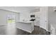 Bright kitchen with a large island, stainless steel appliances, and a sliding glass door at 98 Ethel Ln, Angier, NC 27501