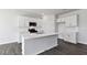 Modern kitchen with white cabinets, stainless steel appliances, and a large island at 98 Ethel Ln, Angier, NC 27501