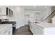 Open kitchen with stainless steel appliances, white cabinets, and a functional center island at 98 Ethel Ln, Angier, NC 27501