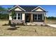 Inviting home featuring a brick foundation and covered porch at 155 Waterwheel Dr, Selma, NC 27576
