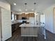 Open kitchen with an island, modern appliances, granite counters, and ample cabinet space at 155 Waterwheel Dr, Selma, NC 27576