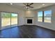 Bright living room with a fireplace and sliding glass door leading to the backyard at 155 Waterwheel Dr, Selma, NC 27576