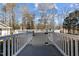 White wooden deck and railing overlooks fenced yard and wooded area at 319 Fox Hollow Dr, Clayton, NC 27527