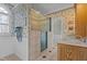 Bathroom featuring floral wallpaper, a glass shower, and a white vanity at 319 Fox Hollow Dr, Clayton, NC 27527
