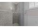 Shower with glass door and tiled walls in a neutral-toned bathroom at 319 Fox Hollow Dr, Clayton, NC 27527