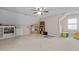 Spacious carpeted bonus room with sloped ceilings and built-in shelves and storage at 319 Fox Hollow Dr, Clayton, NC 27527