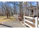 Charming gray cottage with a white picket fence, perfect for a tranquil retreat in the woods at 319 Fox Hollow Dr, Clayton, NC 27527