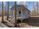 Cozy gray cottage featuring a charming front porch and surrounded by a natural wooded setting at 319 Fox Hollow Dr, Clayton, NC 27527