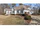 White house with brown roof, landscaping, and a two-car garage at 319 Fox Hollow Dr, Clayton, NC 27527