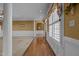 Foyer featuring wainscoting, wood floors, and view to living room through arched doorway at 319 Fox Hollow Dr, Clayton, NC 27527