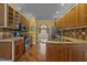 Bright kitchen featuring stainless steel appliances, granite countertops and warm wood cabinetry at 319 Fox Hollow Dr, Clayton, NC 27527