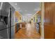 Spacious kitchen with stainless steel appliances, wooden cabinets, and hardwood floors leading to living space at 319 Fox Hollow Dr, Clayton, NC 27527