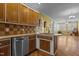Kitchen island with stainless steel dishwasher, tile backsplash, and hardwood floors at 319 Fox Hollow Dr, Clayton, NC 27527