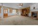 A large living room featuring neutral carpet, an entertainment center, a brick fireplace, and view to the foyer at 319 Fox Hollow Dr, Clayton, NC 27527