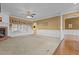 A spacious living room featuring neutral carpet, a brick fireplace, columns, and hardwood flooring at 319 Fox Hollow Dr, Clayton, NC 27527
