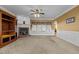 An interior shot of a living room featuring a fireplace, neutral carpet, and archway to the foyer at 319 Fox Hollow Dr, Clayton, NC 27527