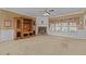 A large living room featuring a fireplace, neutral carpet, an entertainment center, and large windows at 319 Fox Hollow Dr, Clayton, NC 27527