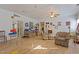 Bright living room featuring hardwood floors, ceiling fan, and decorative wall art at 319 Fox Hollow Dr, Clayton, NC 27527