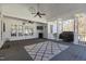 Covered porch with a ceiling fan, outdoor grill, and view to the fenced-in backyard at 319 Fox Hollow Dr, Clayton, NC 27527