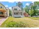 Backyard view of a house with a white porch and green grass at 3302.5 Hall Pl, Raleigh, NC 27607