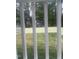 View of a fenced backyard with grass, trees, and a neighboring house through the railing at 3302.5 Hall Pl, Raleigh, NC 27607