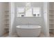 Bright bathroom featuring standalone tub with shelving and a stylish hanging light fixture at 3302.5 Hall Pl, Raleigh, NC 27607