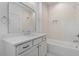 Bright bathroom featuring a white vanity with marble countertop and tiled shower/tub combo at 3302.5 Hall Pl, Raleigh, NC 27607