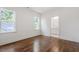 Bedroom features hardwood floors, two windows and door into the adjoining bathroom at 3302.5 Hall Pl, Raleigh, NC 27607