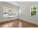 Bright bedroom featuring hardwood floors and large windows for ample natural light at 3302.5 Hall Pl, Raleigh, NC 27607
