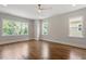 Sunlit bedroom features hardwood floors, neutral walls, and three large windows at 3302.5 Hall Pl, Raleigh, NC 27607