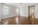 Open bedroom showcasing hardwood floors, neutral paint, and ample natural light from multiple windows at 3302.5 Hall Pl, Raleigh, NC 27607
