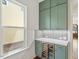 Charming butler pantry with sage green cabinets, wine cooler, and stylish backsplash at 3302.5 Hall Pl, Raleigh, NC 27607
