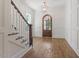 Bright foyer with hardwood floors, white trim, and dark wood stairs at 3302.5 Hall Pl, Raleigh, NC 27607