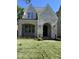Stylish two-story home with white brick facade, arched entryway, and well-manicured lawn at 3302.5 Hall Pl, Raleigh, NC 27607