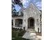 Charming whitewashed brick home featuring an arched entryway and professionally landscaped front yard at 3302.5 Hall Pl, Raleigh, NC 27607