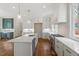 Bright kitchen featuring an island with sink and stainless steel appliances at 3302.5 Hall Pl, Raleigh, NC 27607