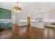 Large kitchen with hardwood floors, white cabinets, stainless appliances, and a spacious center island at 3302.5 Hall Pl, Raleigh, NC 27607